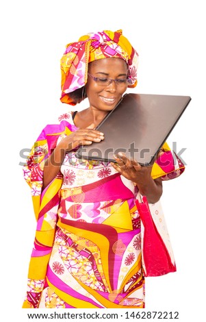 beautiful adult businesswoman holding a computer while smiling