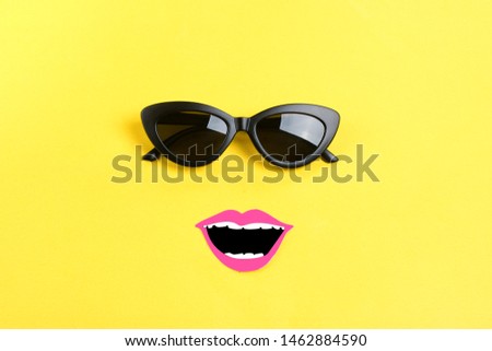 Hello summer The sun with stylish black sunglasses, smiling mouth on yellow background Flat lay Summer, vacation, holiday, party, travel creative concept