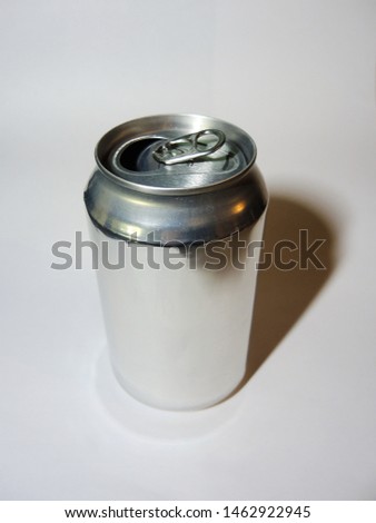 Empty aluminum can for drinks without labels photographed on a light gray background