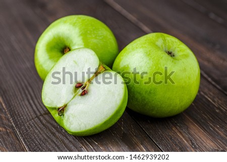 Ripe green apples and apple slices on old wooden background.Vegan and vegetarian concept.Concept for healthy eating and nutrition