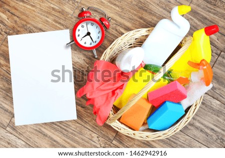 Cleaning service background with empty white place for your text. Household chemicals and clock. Concept of cleanliness and freshness in the house with a saving time. 