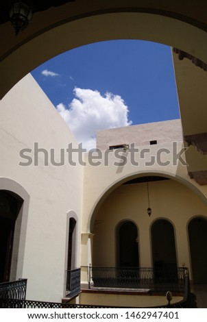 building interior with arches and sky in the background