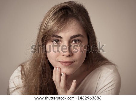 Close up portrait of young pretty caucasian teen woman with blond hair and beautiful smile. Isolated on neutral background. Feeling confident posing and modeling. In lifestyle and beauty concept.