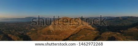 Aerial drone panoramic view of iconic uphill medieval castle of Acrocorinth an ancient citadel overlooking ancient Corinth, Peloponnese, Greece Royalty-Free Stock Photo #1462972268