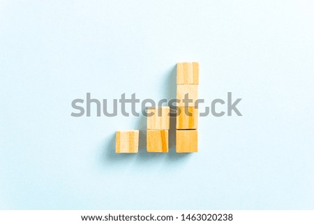 Growth Bar Chart Graph Diagram with wooden block toys on blue background. Successful Business concept.
