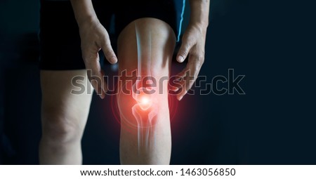 Elderly woman suffering from pain in knee. Tendon problems and Joint inflammation on dark background. Royalty-Free Stock Photo #1463056850