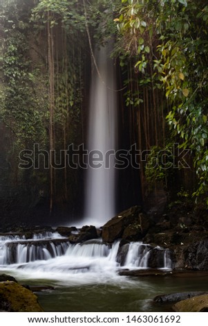 Waterfall landscape. Beautiful hidden waterfall in tropical rainforest. Jungle river. Adventure and travel to Asia. Sumampan waterfall in Ubud, Bali, Indonesia. Slow shutter speed, motion photography.