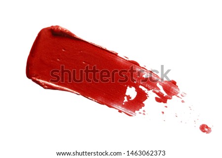 Red lipstick smear smudge swatch isolated on white background. Cream makeup texture. Macro cosmetic product stroke swipe sample
