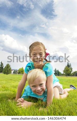 Happy kids playing in the grass on summer day