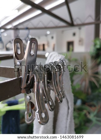 Metallic or plastic hangers and clips use to dry clothes outdoor at the open space porch.
