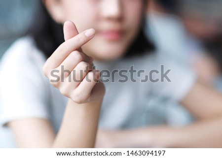 Asian girl make Korean symbol hand heart