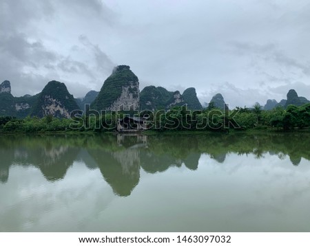 Mountains with reflection on water lake on cloudy day