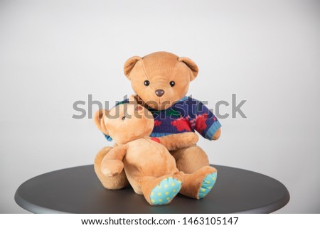 Two teddy bears Cute brown On a gray table White background, 
Two cute teddy bears Gifts for lovers