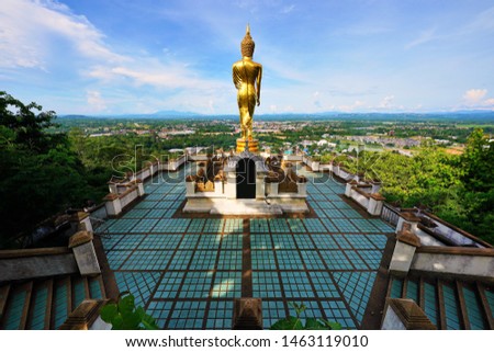 Phra Phuttha Maha Udom Mongkhon Nanthaburi Si Nan Buddha Statue standing on a lotus with giving blessing posture turn front to Nan town