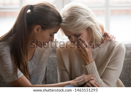 Grown up daughter soothe aged mother holds her hand feel empathy give her moral support elderly woman crying wipe tears with tissue, health problem disease, divorce broken heart adult child supporting Royalty-Free Stock Photo #1463151293