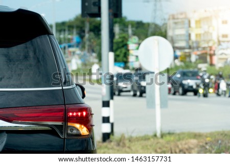 Brake cars on asphalt roads during rush hours for travel or business work. Open turn light signal.