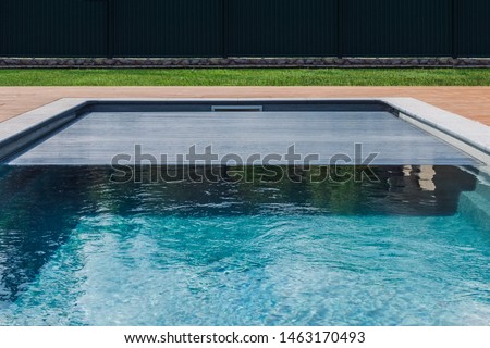 Span for pool. Rolling coating. Pool protection. Rollete. 
Security. Pure water. 
Pool protection system. Royalty-Free Stock Photo #1463170493