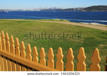 View across a Fence towards Sydney's distant Skyline