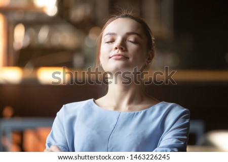 Close up of peaceful young woman relax lean back sitting with eyes closed dreaming or visualizing, happy calm female dreamer rest meditating controlling emotions. Stress free, mindfulness concept Royalty-Free Stock Photo #1463226245