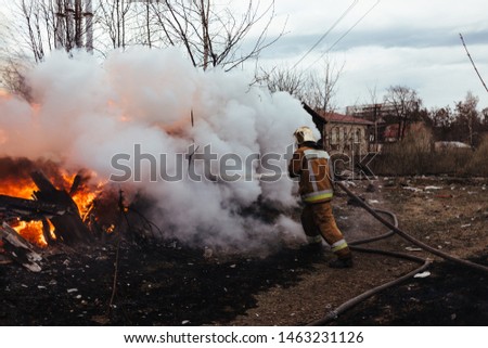 Firefighters extinguish a real fire.