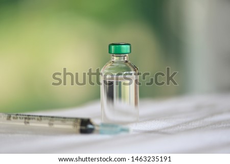 Medicine bottles glass and syringe injection needle on the table / Medication drug bottle equipment medical tool for nurse or doctor 