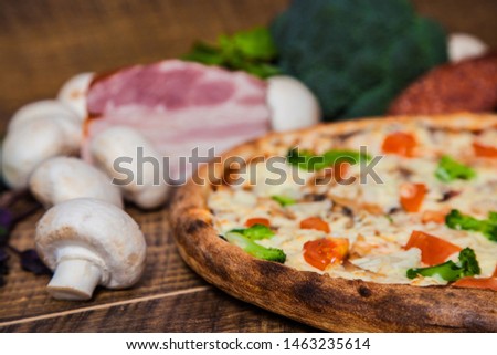 pizza with tomatoes broccoli and salami
