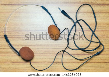 Vintage headphones on a brown wooden background