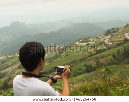 Travel concept for studying natural trail Asian man with photography, mountain views during the holiday. With copy space for text.