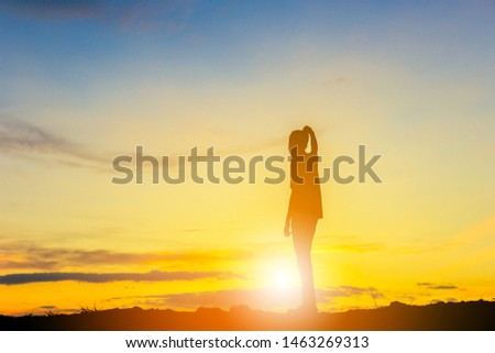 Silhouette of Man Celebration Success Happiness on a mountain top Evening Sky Sunset Background, Sport and active life Concept