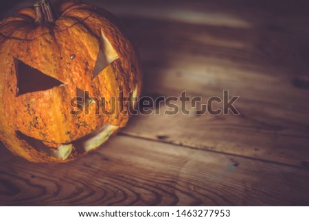 Halloween Pumpkin jack lantern on wood. Copy space
