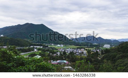 Beautiful Exterior View of Japanese Community with Rice Field. The Village Surrounding with Mountains