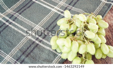 green fruit on green flanel on old wooden table
