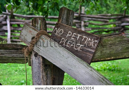 carved wooden sign to warn people not to pet the farm animals