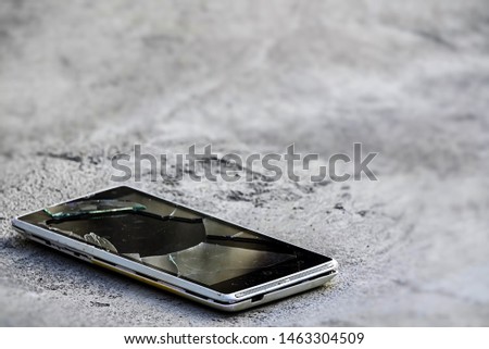 The smartphone fell on the ground of the accident Broken glass broken screen communication insurance