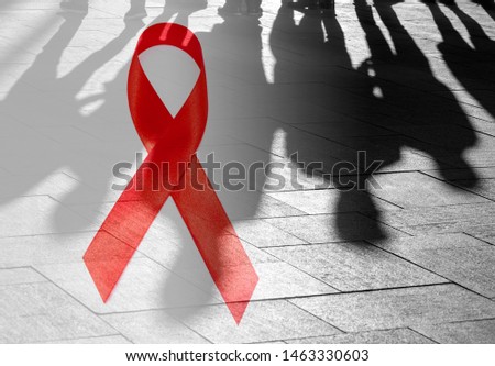 Shadows of People and Red Ribbon as Symbol of Hope - Hive Aids conceptual Picture about situation in the World 