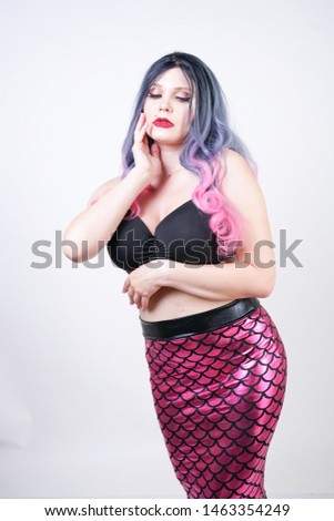 Gothic plus size adult mermaid on white studio background