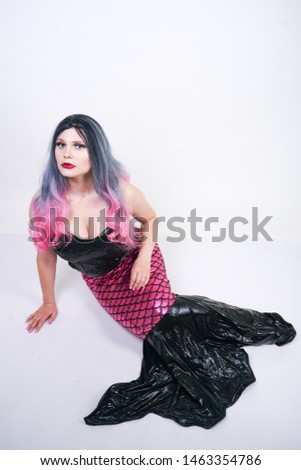 Gothic plus size adult mermaid on white studio background