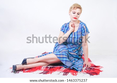 cute plus size blonde girl in a long rustic plaid blue dress