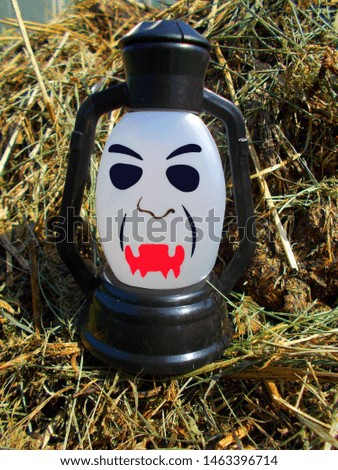 A lamp with a terrible face. A scary mug looks at you. Halloween