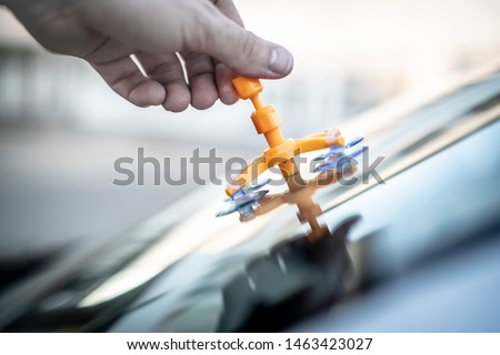 Repair of a rockfall in the windshield of a car Royalty-Free Stock Photo #1463423027