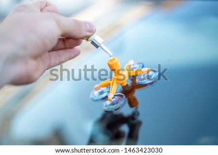 Repair of a rockfall in the windshield of a car Royalty-Free Stock Photo #1463423030