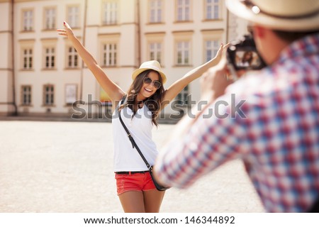 Happy tourist girl posing for photo 