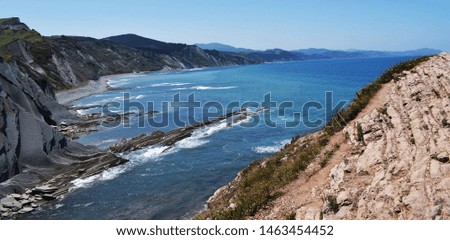 Landscape of mountains and cliffs beside the sea in summer.