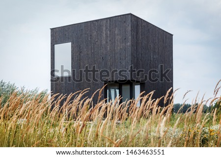 Building facade made of burnt wooden boards. Yakisugi is a traditional Japanese method of wood preservation. Burning wood Royalty-Free Stock Photo #1463463551