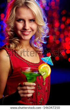 Image of happy girl holding cocktail at party