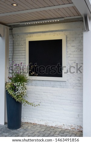 Mock up. Blank blackboard board on white brick wall