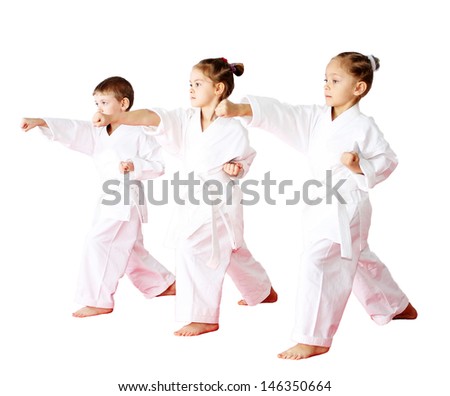 Three athletes in a kimono on a white background beat punch arm Royalty-Free Stock Photo #146350664
