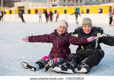 Brother and sister fell while skating and having fun on the ice