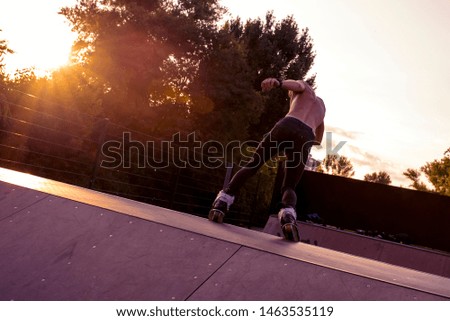 Roller skater practicing in a skate park in sunset