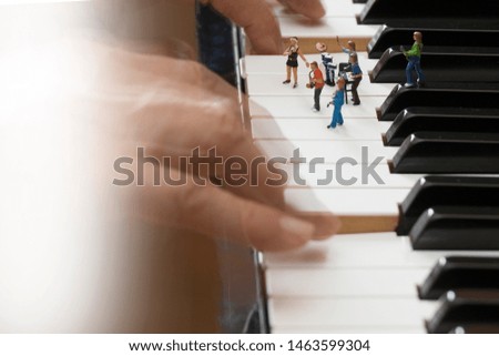 The composer on the piano creating for a rock band, using as a concept of the Day of the Musical Author and Composer, white background